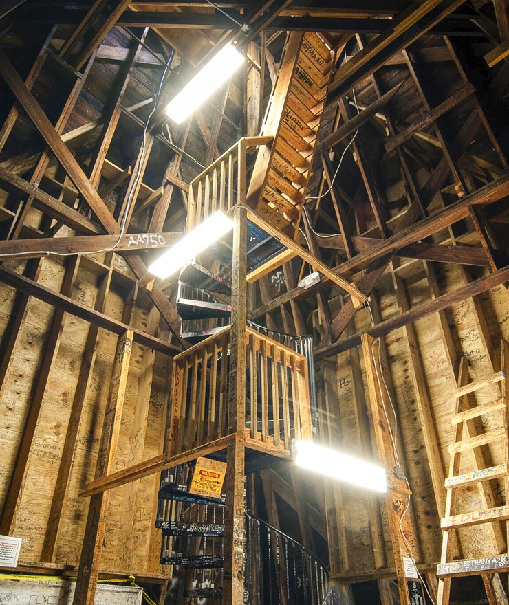 Signatures are shown covering the staircase and walls inside the tower in the Godsey Administration Building in Macon.