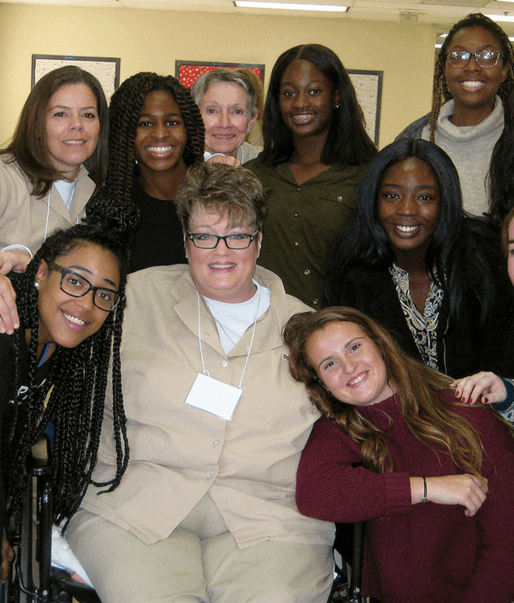 Mercer students and women incarcerated at Pulaski State Prison pose for a photo during a Building Community/Inside-Out class.