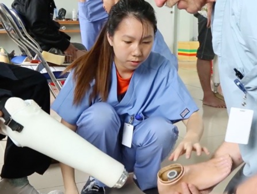 Mercer On Mission Vietname team members work on a prosthetic leg.