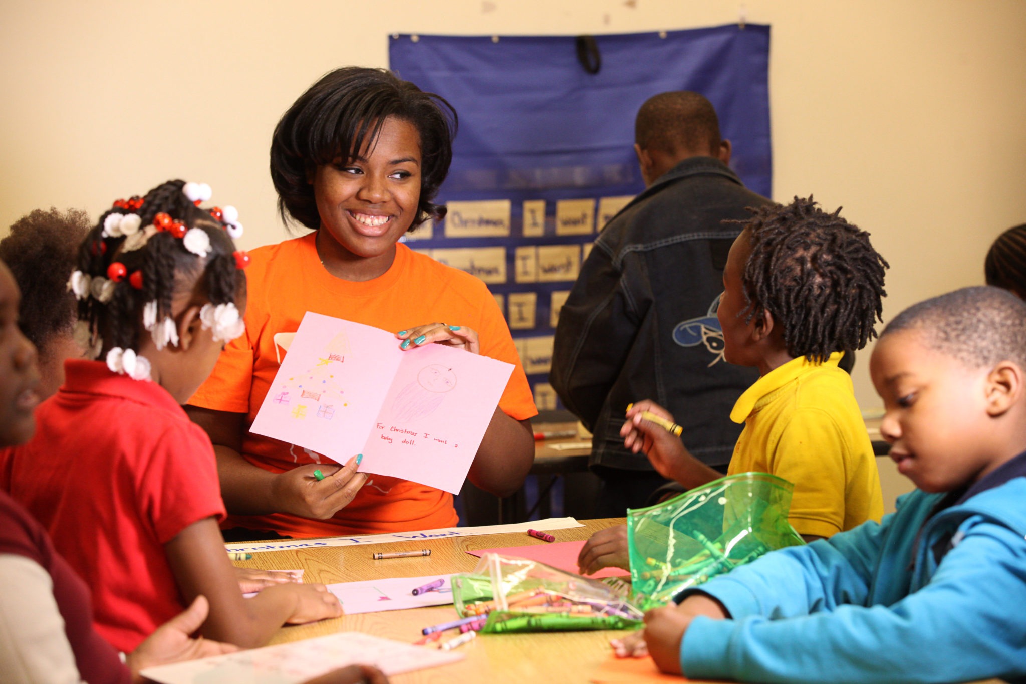 A Mercer University student works with young children to help improve reading scores.