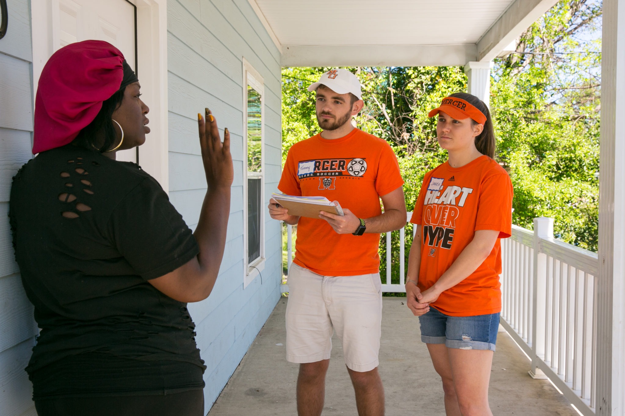 Mercer University students talk to a woman in the community as part of the 2017 Mercer Service Scholars program.