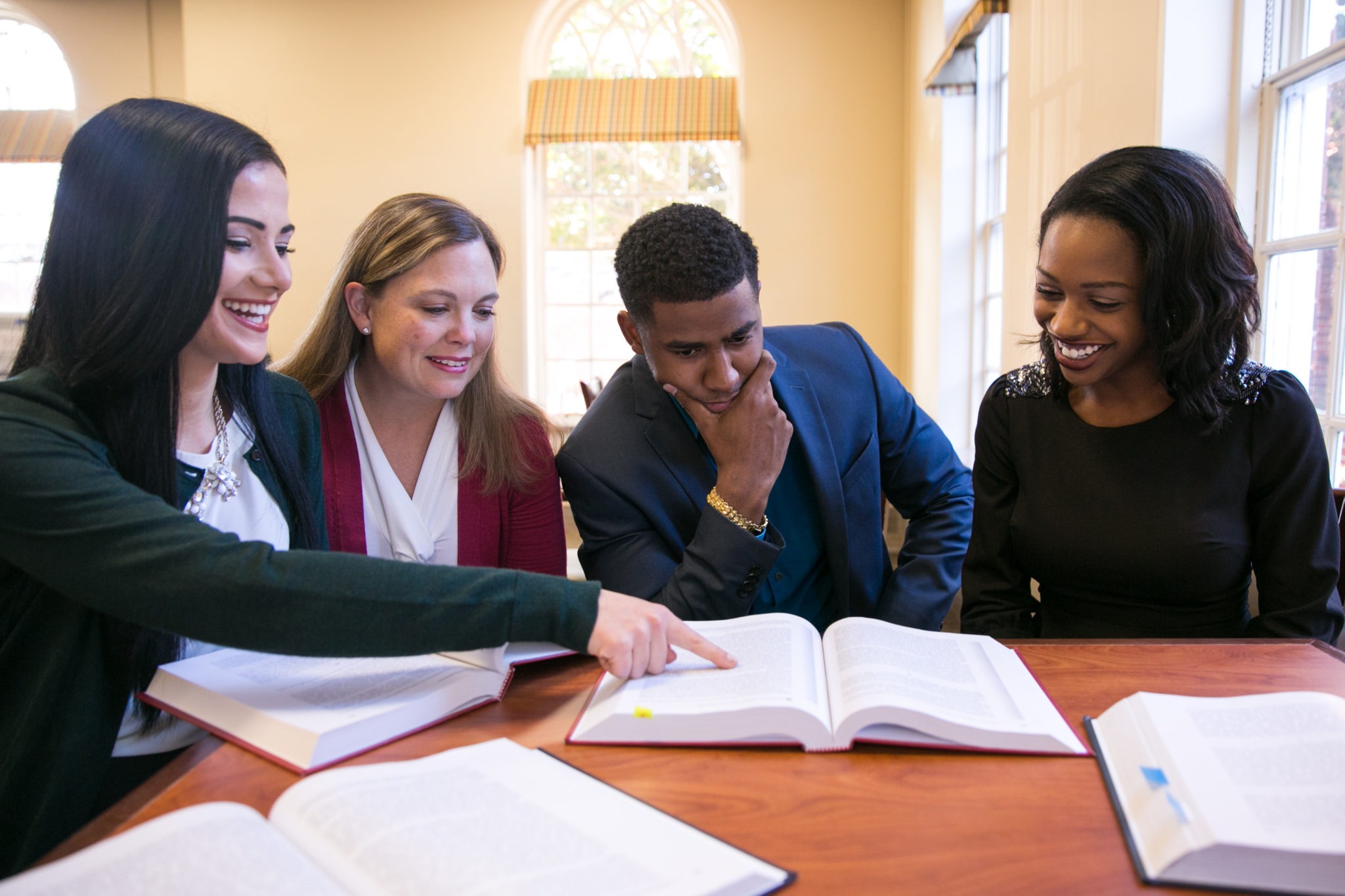 Students study together around a table.