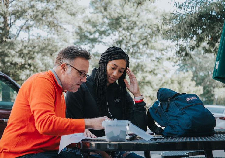 Student and art professor sketch in Mercer Village