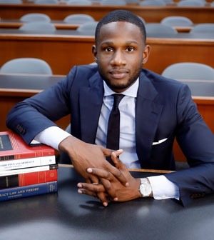 Law student poses with law books