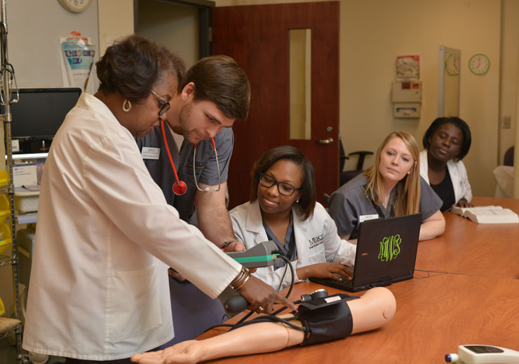 Nursing students learn from professor