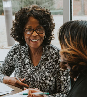 Professor and adult student working at table