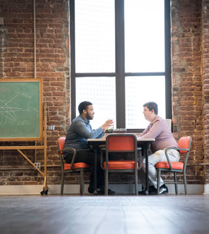 Theology student talking across table