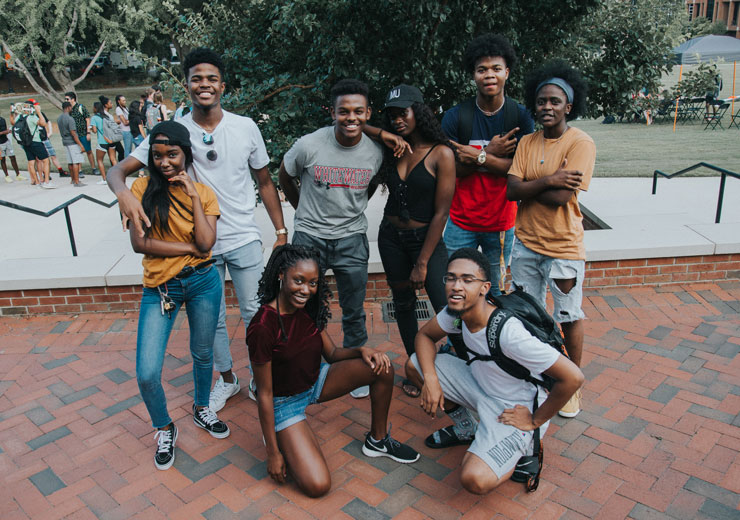 Group of students smile on Cruz Plaza