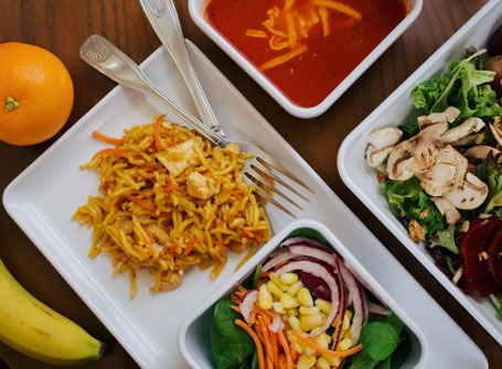 Overhead view of soup, salad, and rice dish