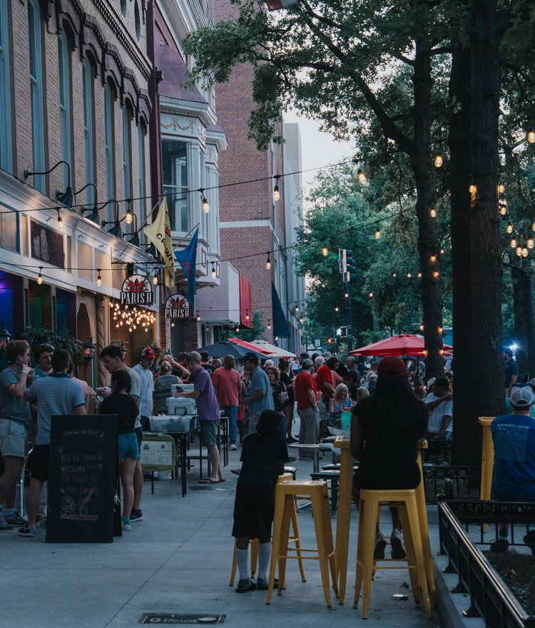 View of downtown Macon with people eating outside at restaurants.