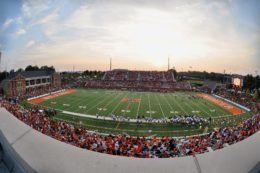 Fans watch a football game inside Five Star Stadium.