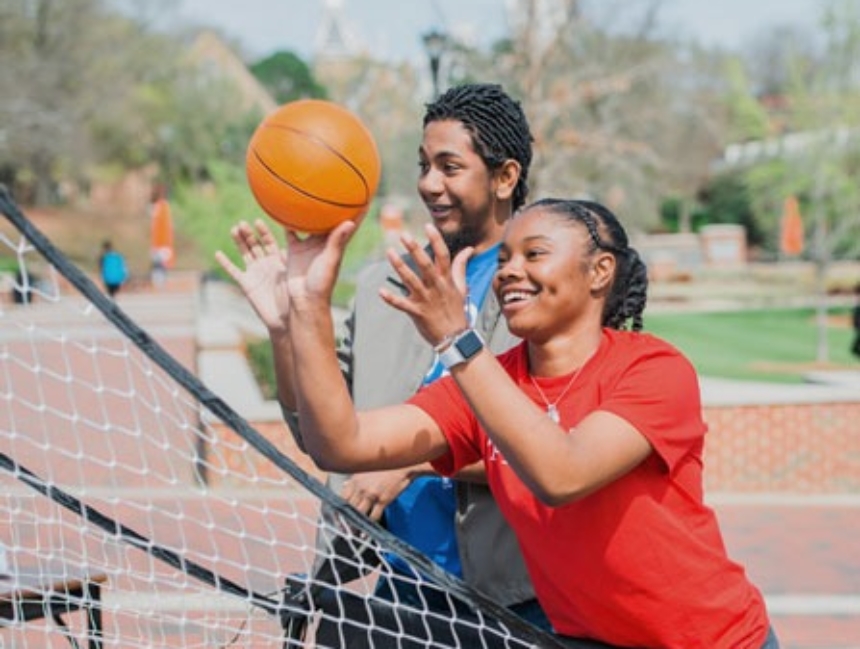 Students playing basketball carnival game