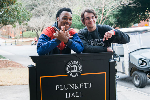 Roommates Kenedy Howery and Eric Houser pose in front of Plunkett Hall.