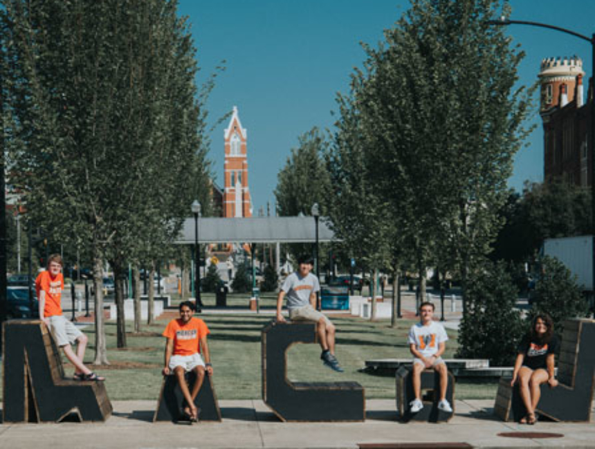 Students posing with large letters spelling Macon