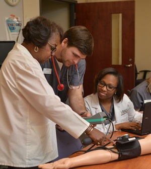 Nursing students learn from professor