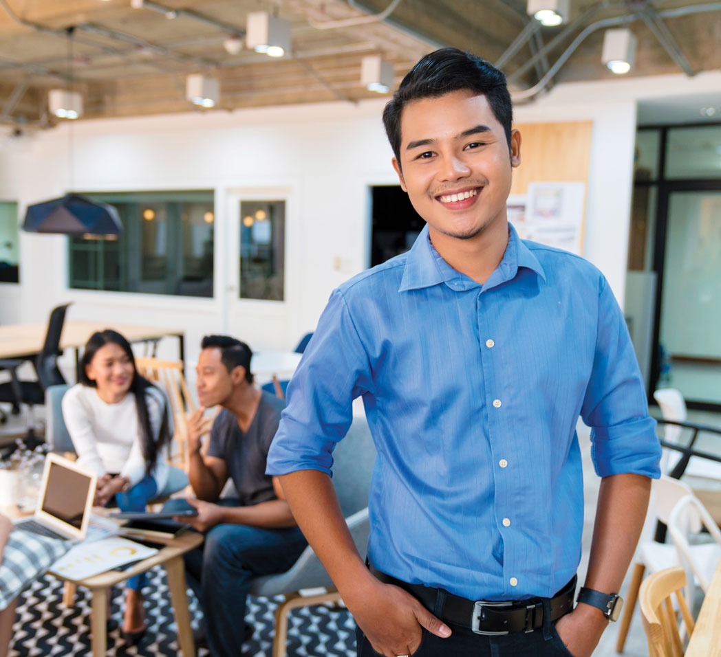 Smiling student with hands at hips