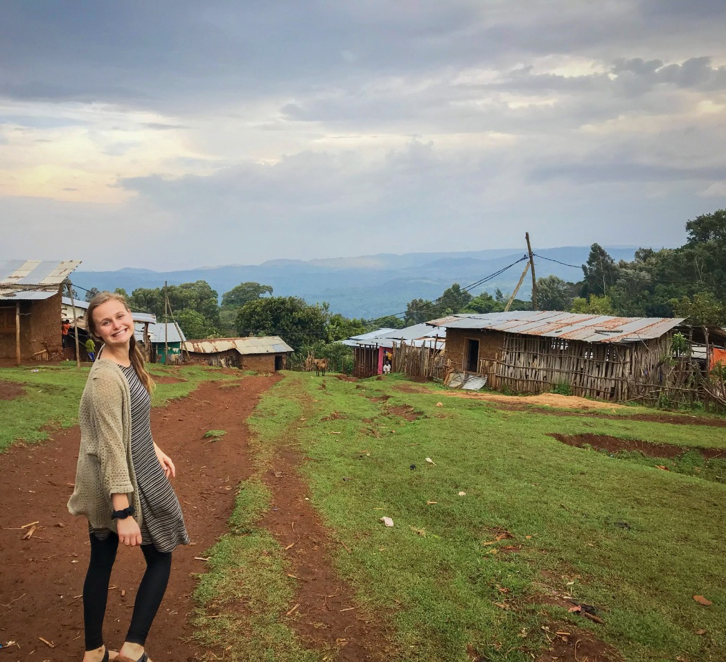 Kaitlyn Koontz stands on a dirt road in her village in Ethiopia