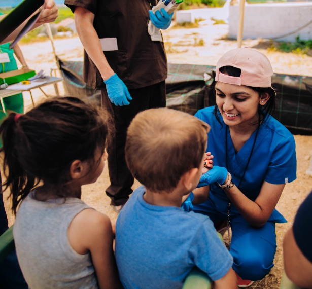 a mercer student gives children a check up in greece