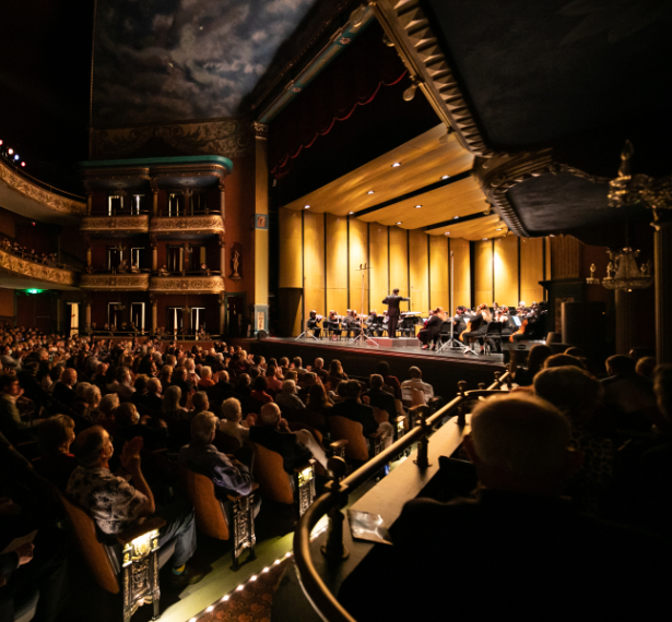 Seated crowd at The Grand Opera House