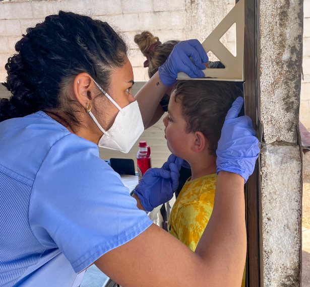Medical personnel measuring a child