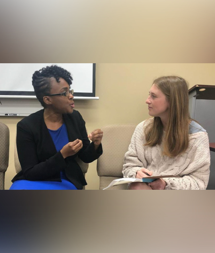 a student and a woman talk