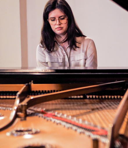 young woman plays piano