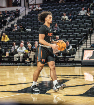 men's basketball player dribbles the ball