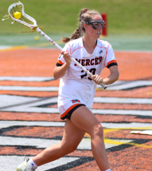 women's lacrosse player runs with stick