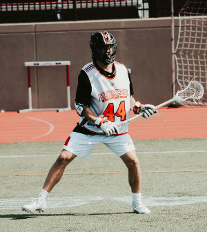 male lacross player holds stick