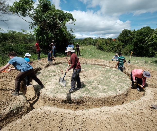 students dig a trench in the shape of a circle