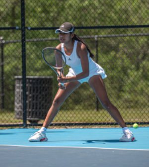 women's tennis player holds a racket