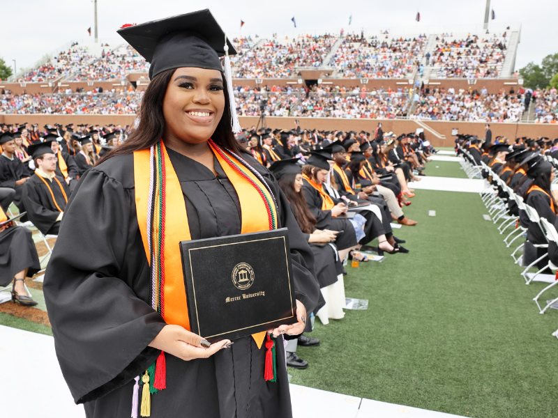 a woman holds a diploma