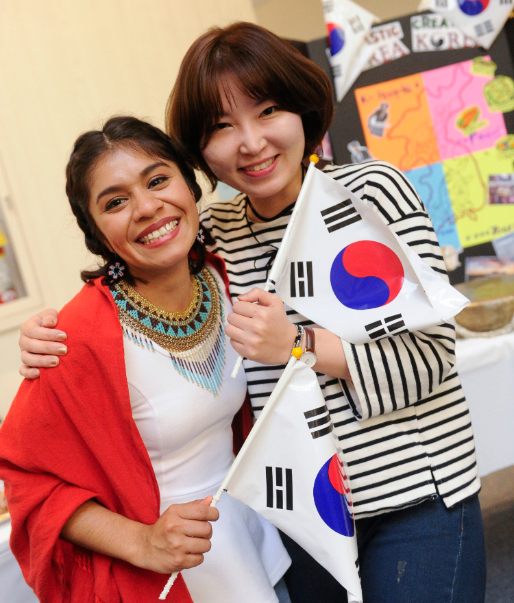 two students hold korean flags
