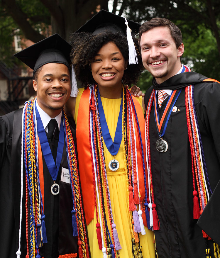 Three graduates smiling for the camera