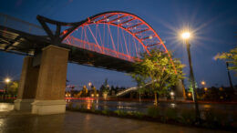 Pedestrian bridge lit orange at night