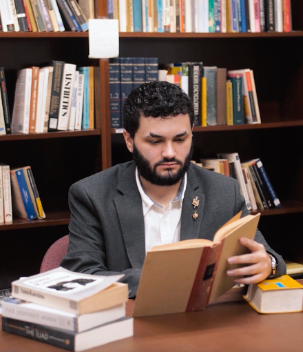Papa Guerrero reads books in the library.