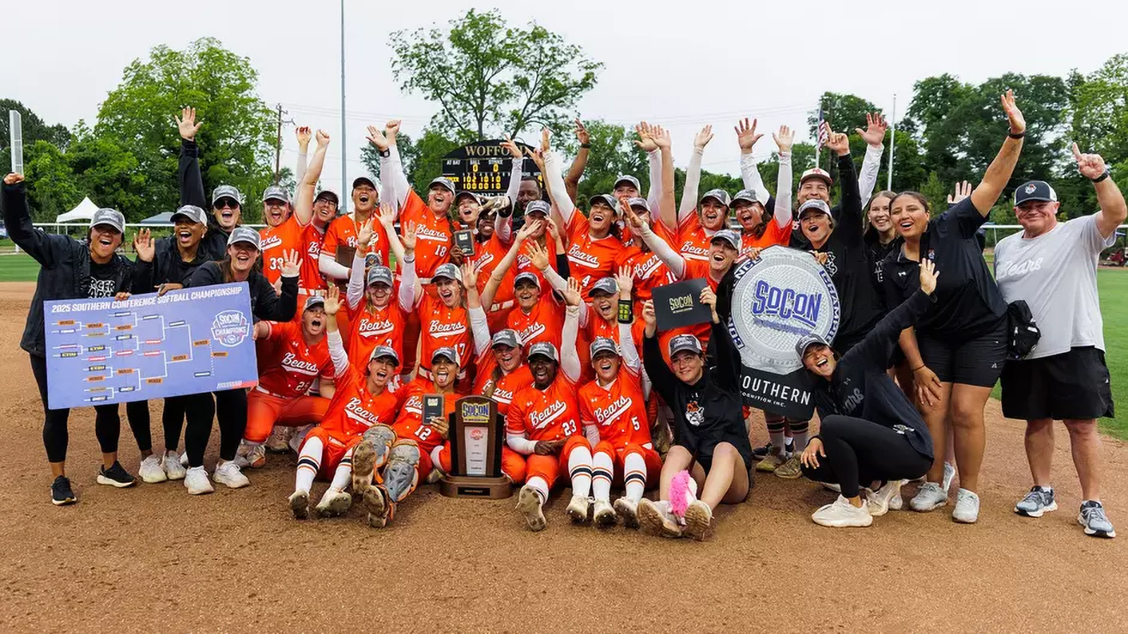 Women's softball team poses for a photo after winning championship