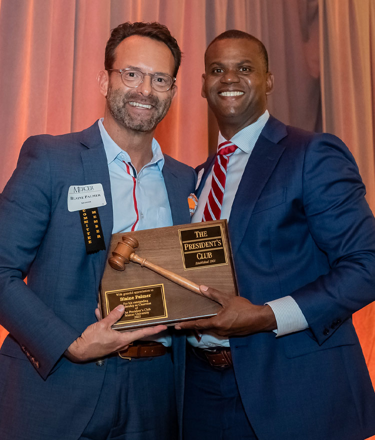 Two men holding a plaque