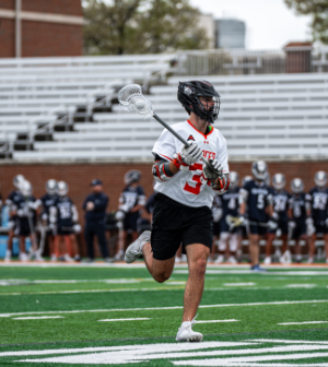 Mercer men's lacrosse player runs on the field during a game.
