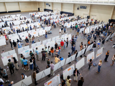 A room full of research posters and people.
